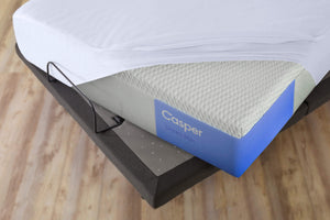 mattress protector covering a mattress on an adjustable bed frame