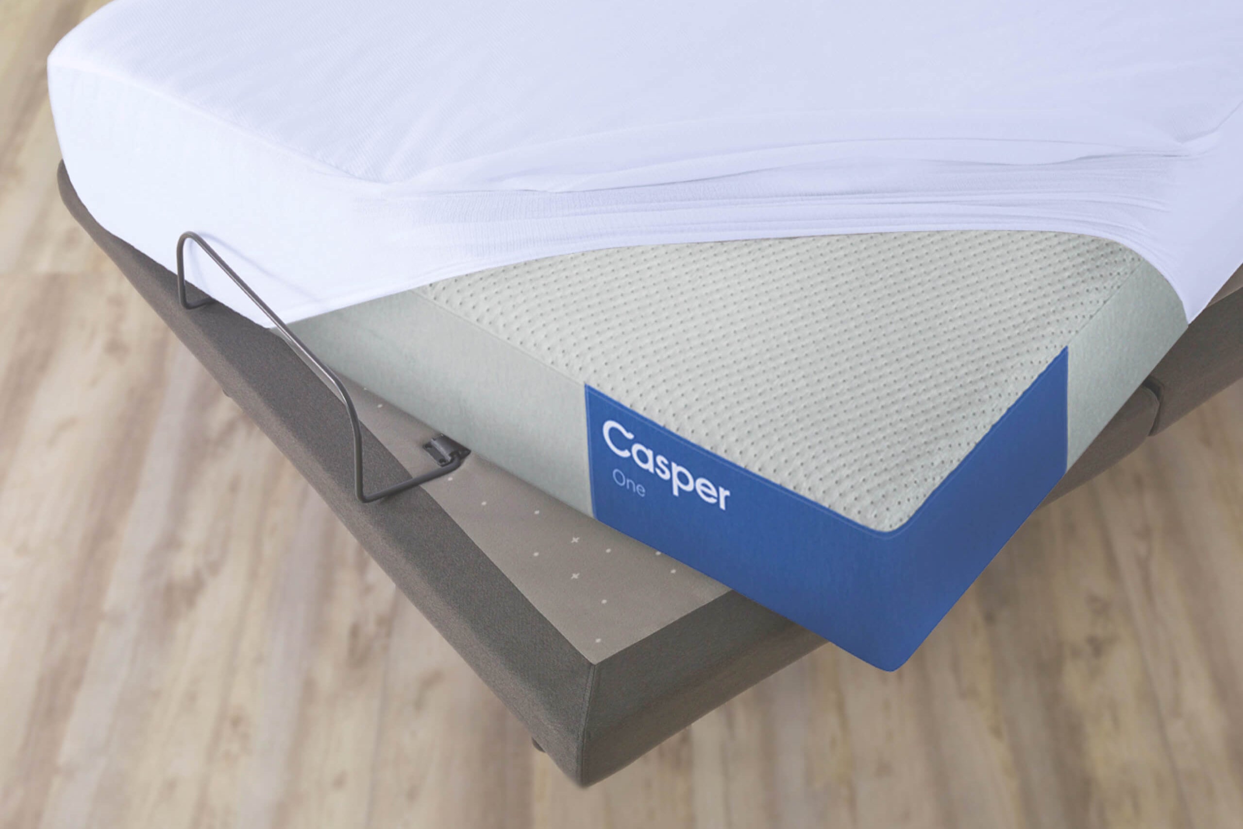 mattress protector covering a mattress on an adjustable bed frame