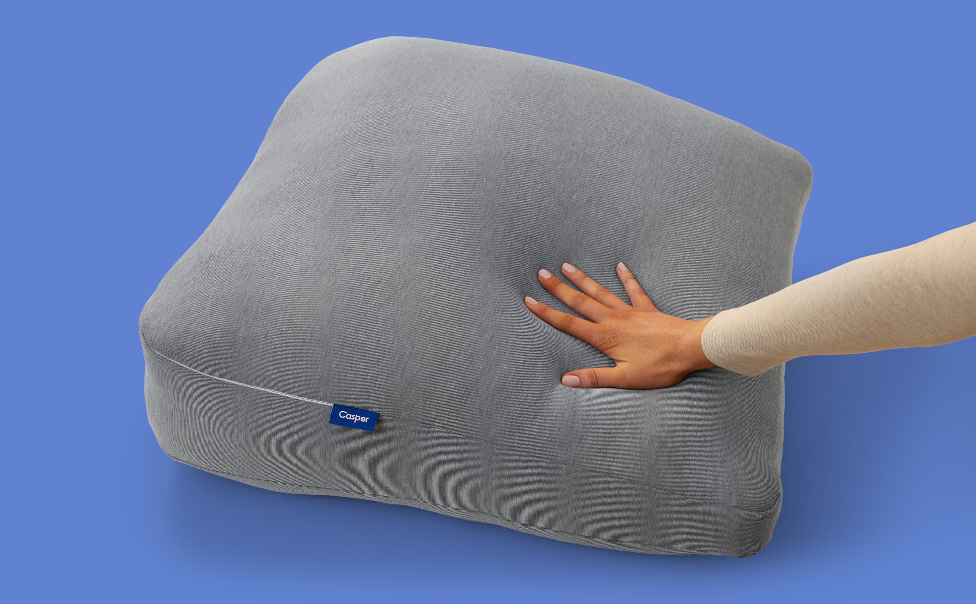 A hand feeling the Casper Backrest Pillow