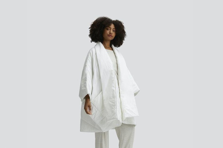A person wearing the Snoozewear Blanket Robe, white