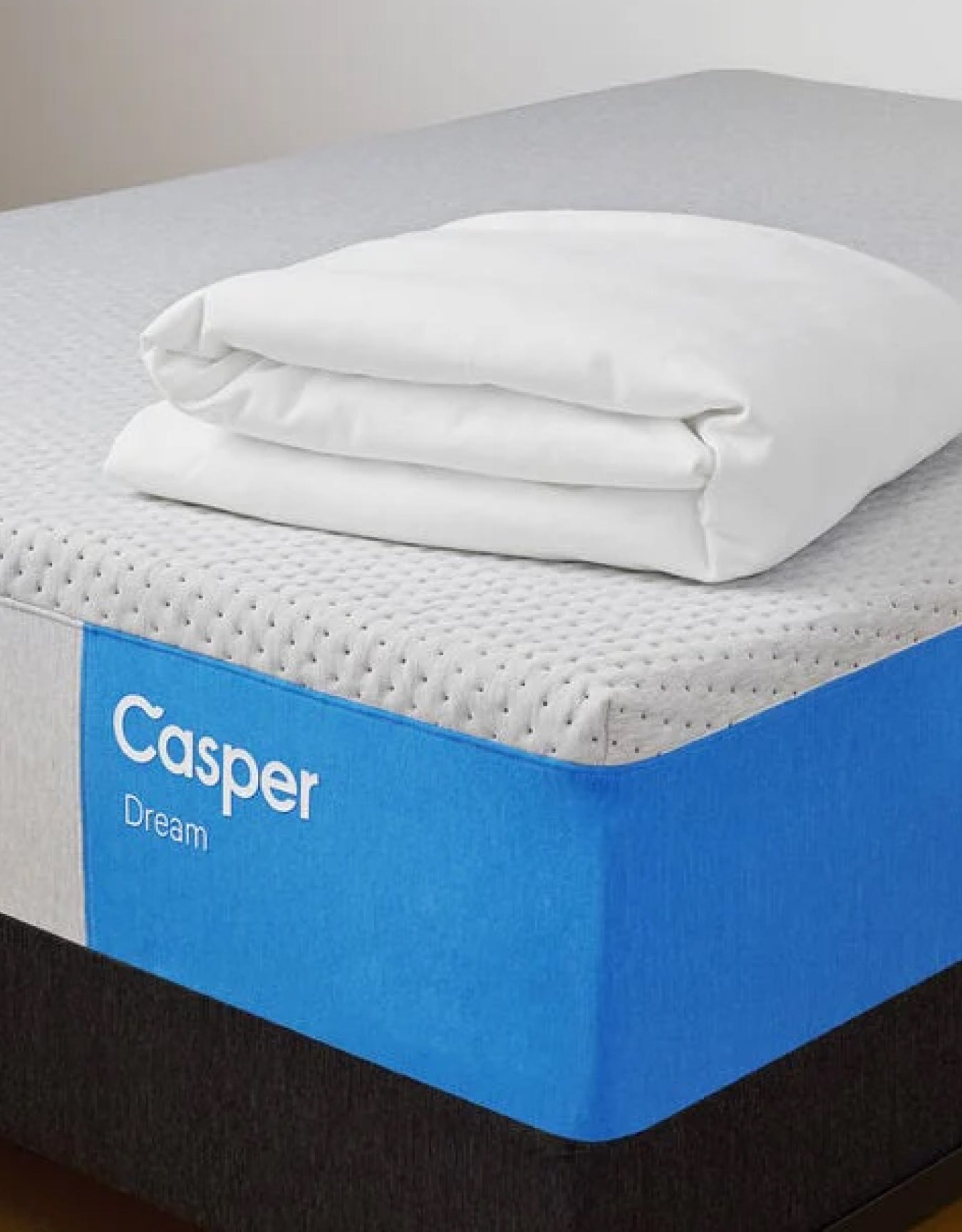 A Casper® 金刚KINGKONG游戏官网 Dream mattress on a foundation with a folded blanket on top.