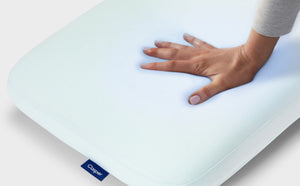 A hand feeling the Hybrid Pillow with Snow Technology.