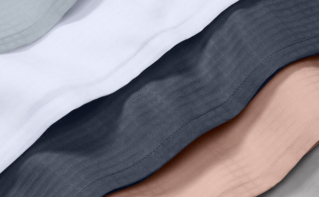 close-up of a few different color sheets staggered on top of each other