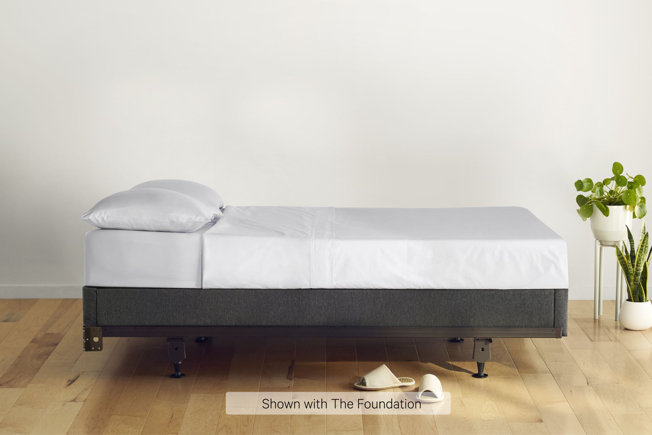 Side view of a made bed. The mattress is on a Foundation on top of Casper's Metal Bed Frame